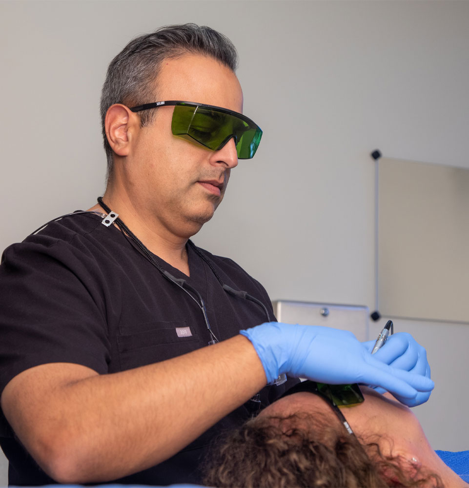 dr haeri performing dental laser procedure