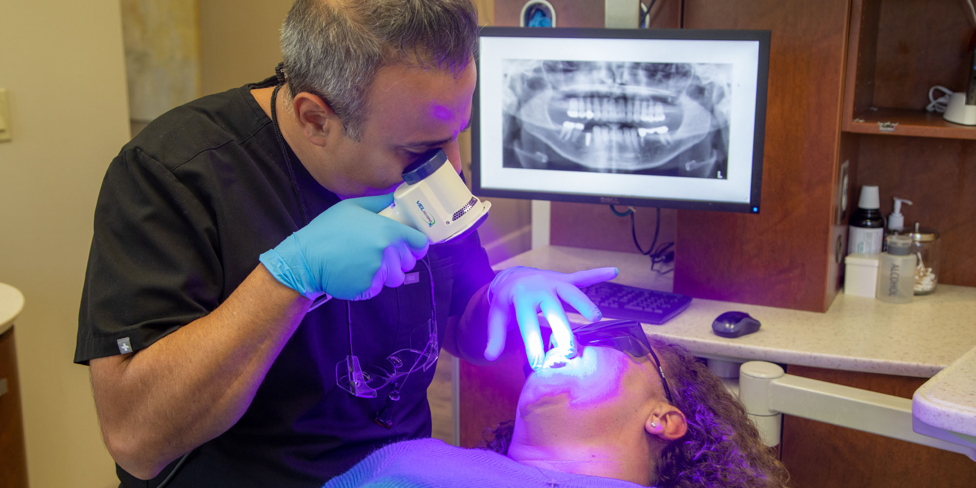 dr haeri performing dental procedure