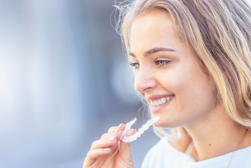 a dental patient using an invisalign clear aligner