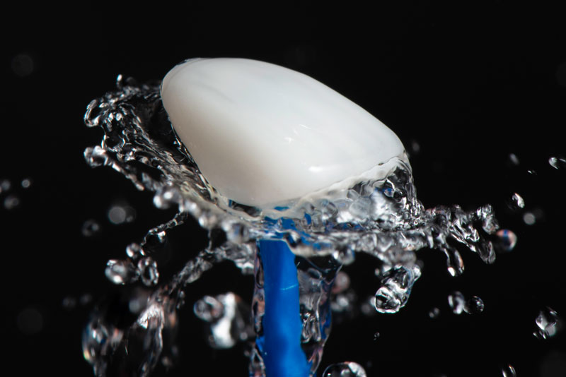 A Single Dental Porcelain Veneer Being Held Up