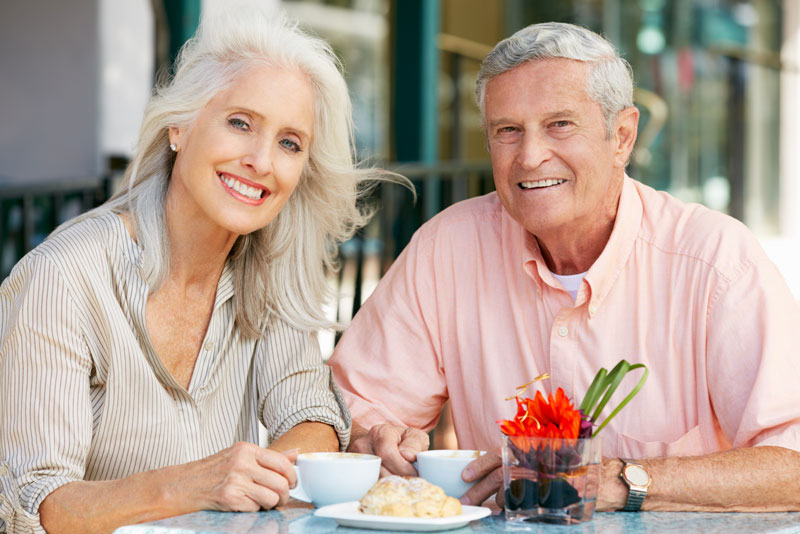 an image of a couple smiling with dental crowns.