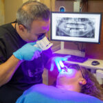 Dr. Haeri working on with a cosmetic dental patient for a smile transformation.