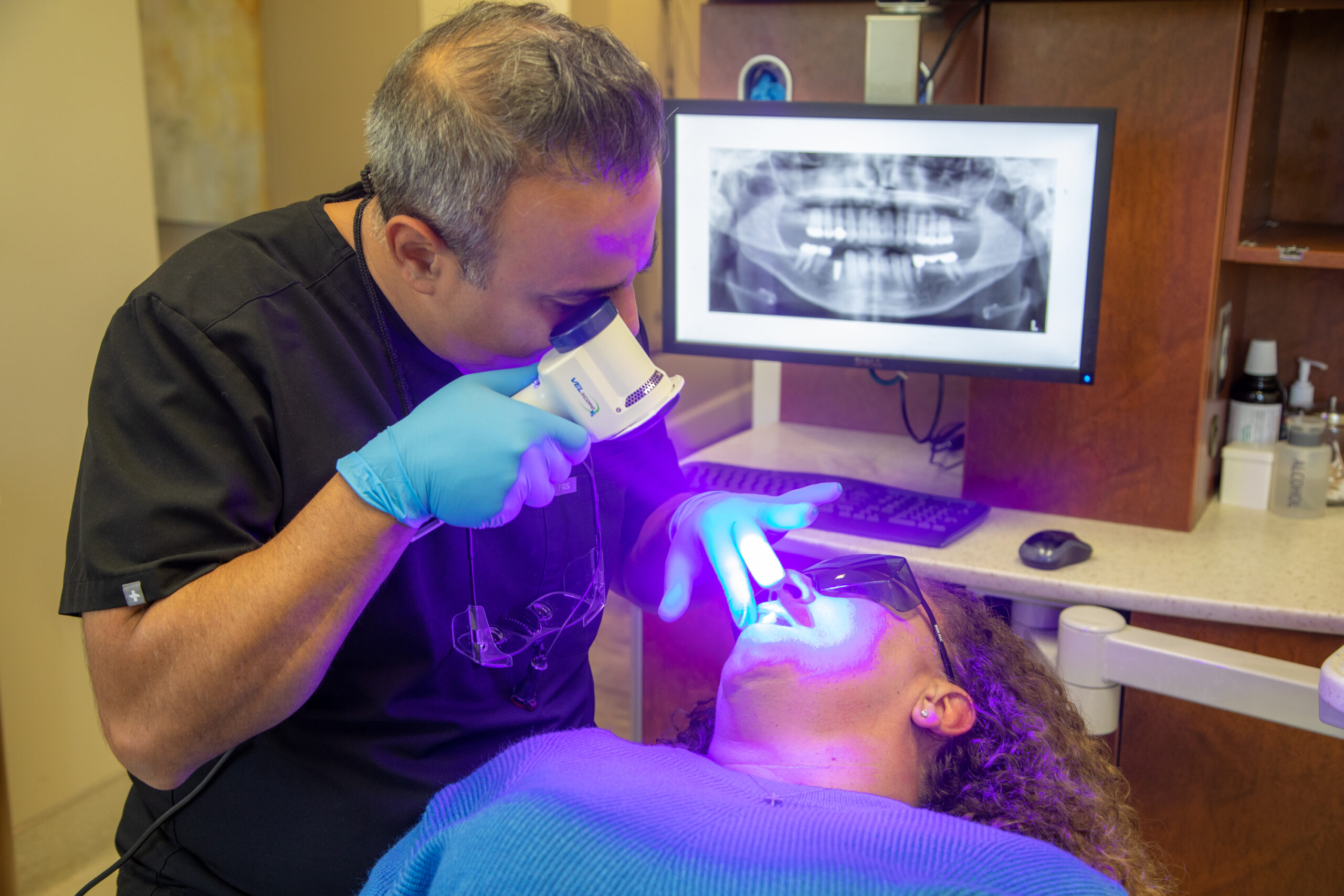 Dr. Haeri working on with a cosmetic dental patient for a smile transformation.