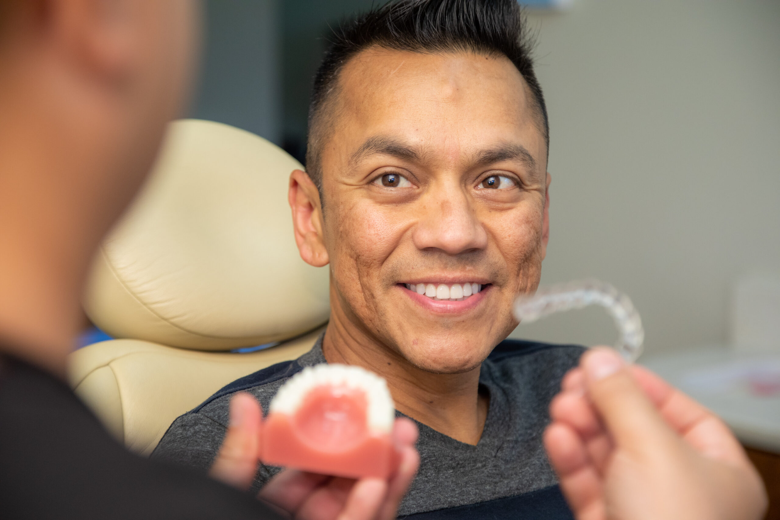 Cosmetic dentist Dr. Ashkan Haeri showing a patient the benefits of clear aligners.